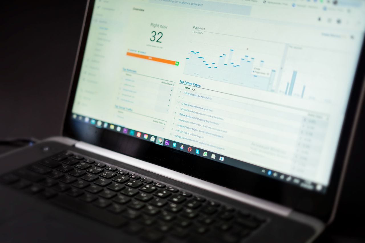 services-04 A laptop displaying an analytics dashboard with real-time data tracking and analysis tools.